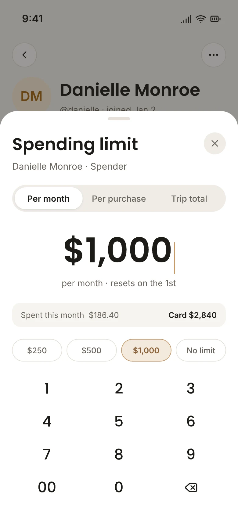 The OneCard app setting a $1,000 monthly spending limit for a member